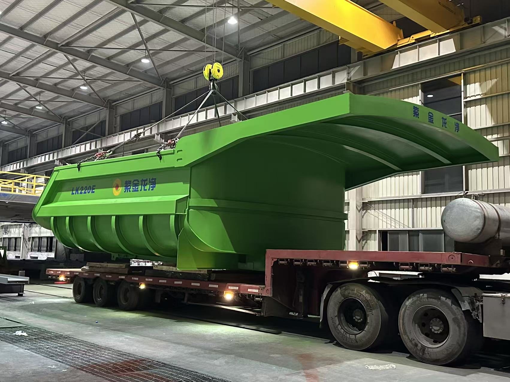 Large painted steel weldment for mining equipment loaded for delivery