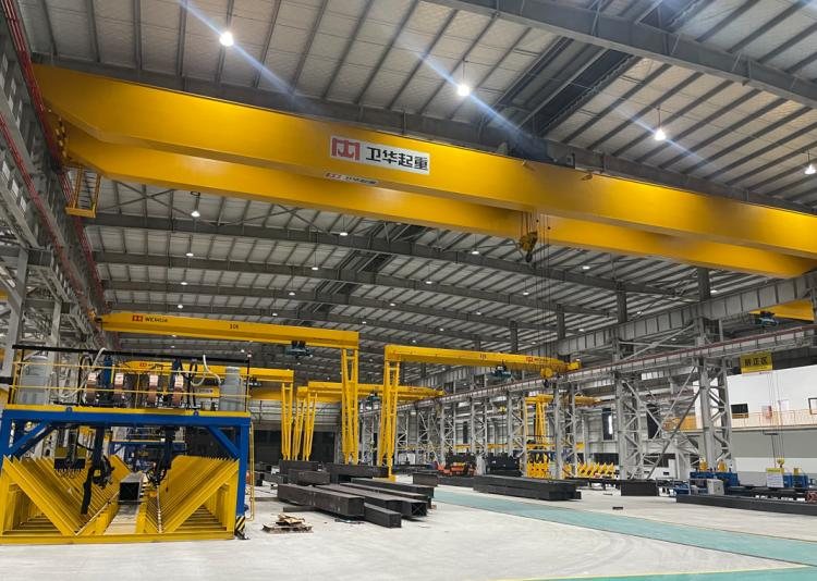 Assembled steel members staged in the fabrication bay ahead of surface treatment
